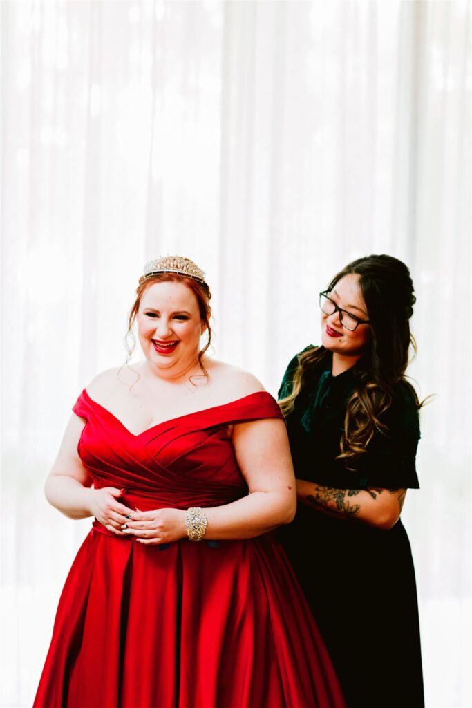 bride in custom red wedding dress getting ready