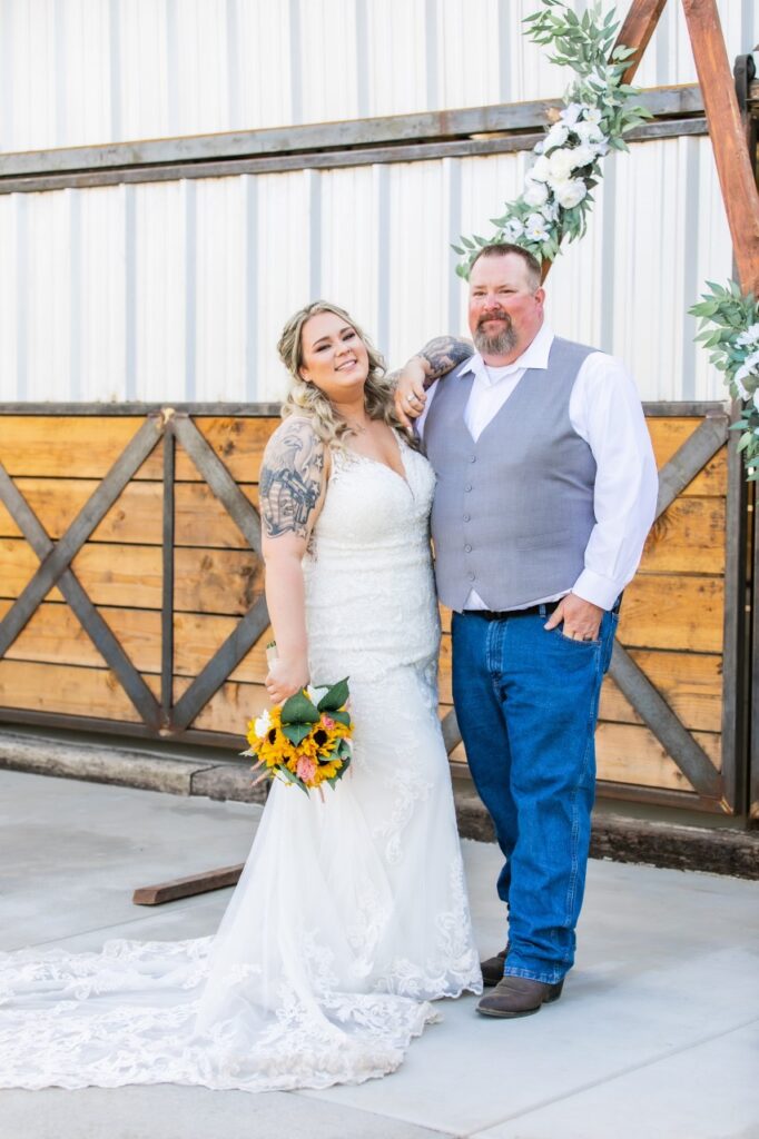 curvy bride wearing lace wedding dress with groom in jeans