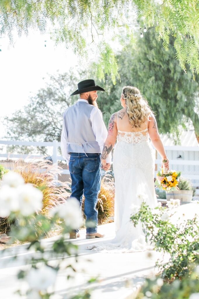 curvy bride wearing lace wedding dress with groom in jeans