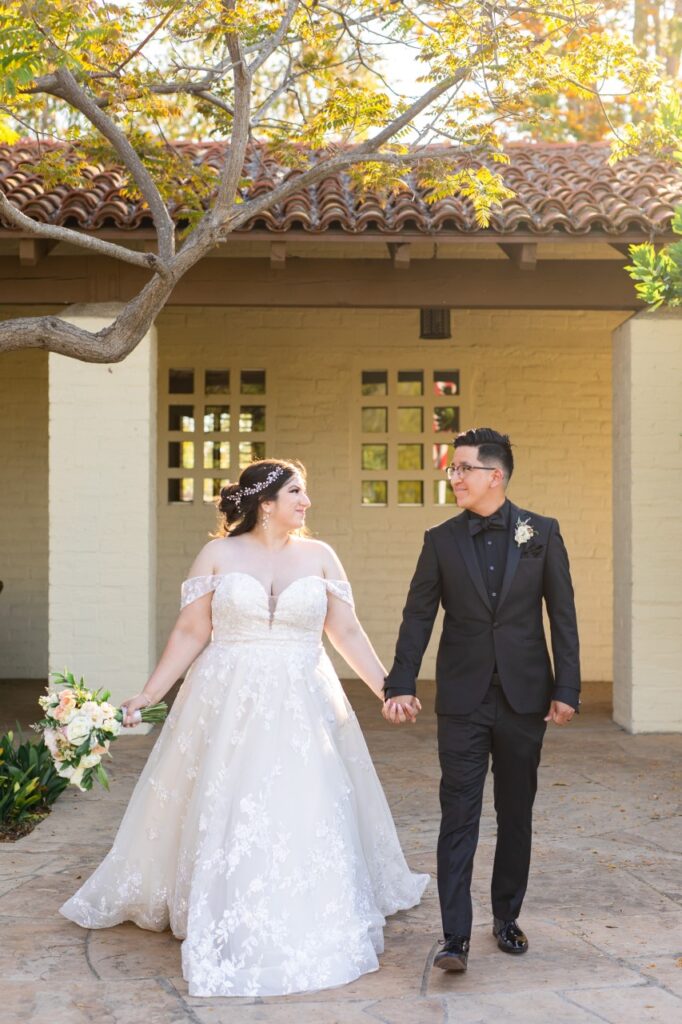 bride wearing lace ballgown with groom in black tux
