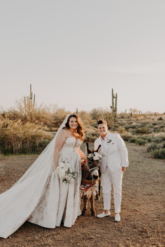 LGBTQIA couple with drink donkey in desert