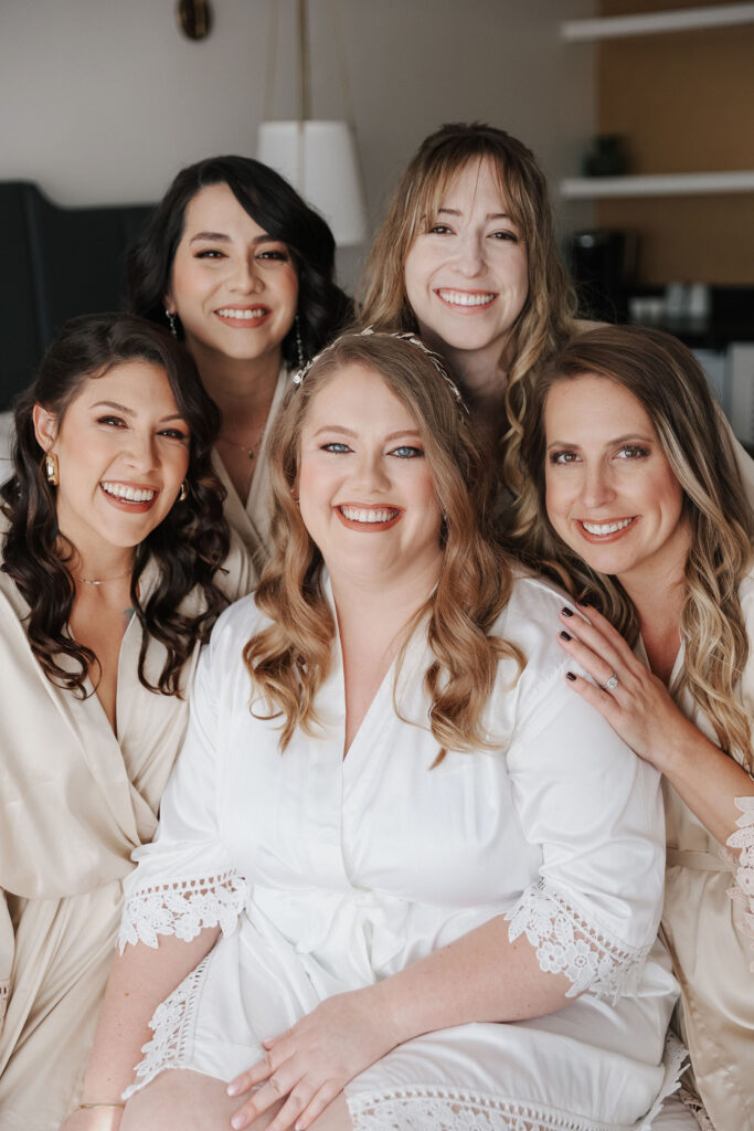 bridesmaids in green dresses around a bride