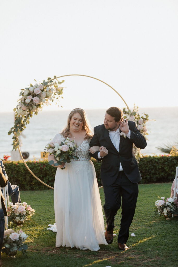 plus size bride in chiffon aline dress with groom on ocean side ceremony