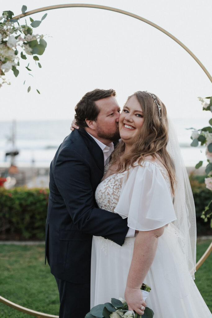 mid size bride wearing chiffon aline wedding dress with custom sleeves