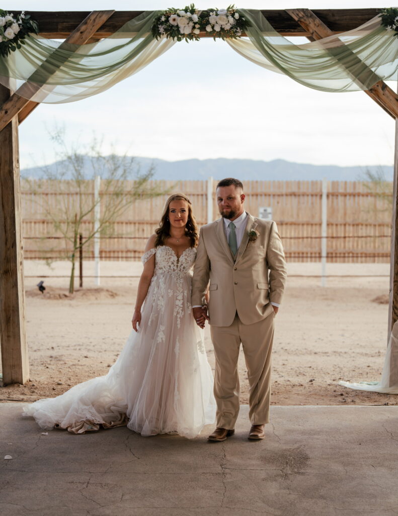 bride in aline wedding with lace tulle groom in tan suit
