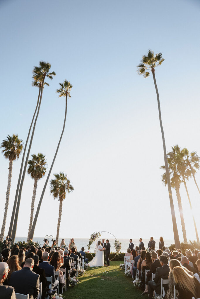 ocean side wedding ceremony with palm trees