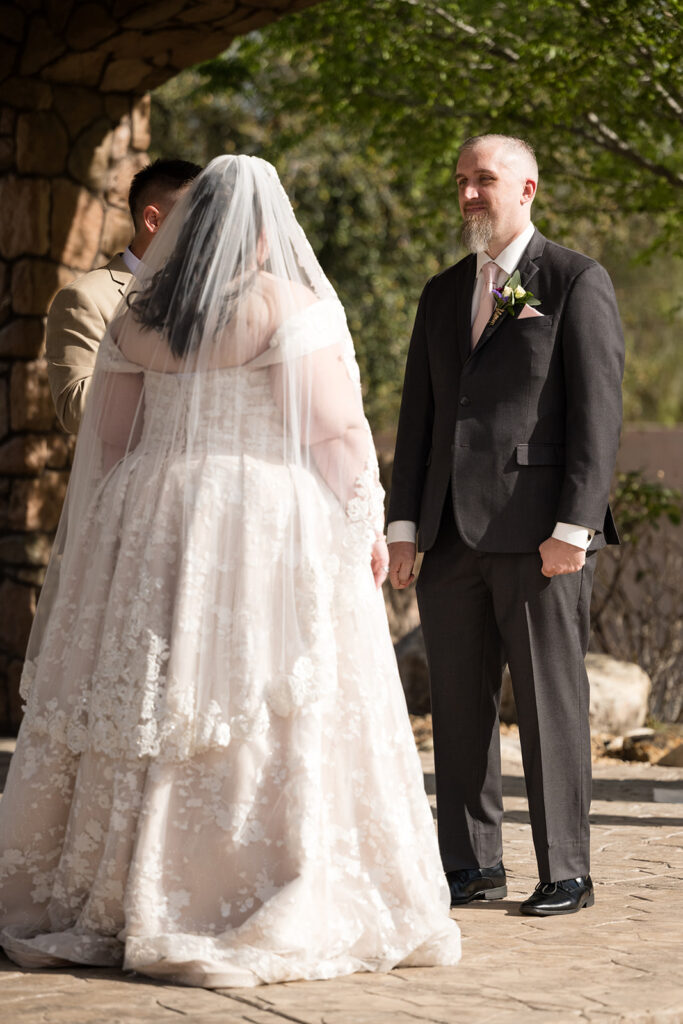 plus size bride wearing champagne and lace wedding dress while groom in black tux at arizona outdoor wedding