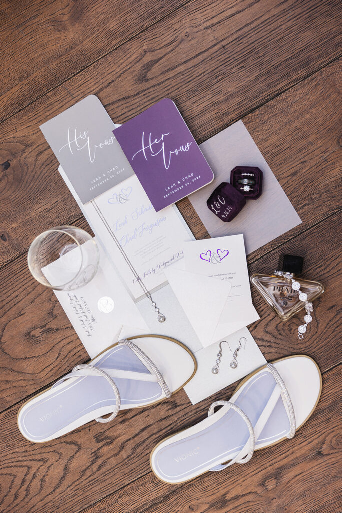 lay flat wedding invitation with purple and white accents