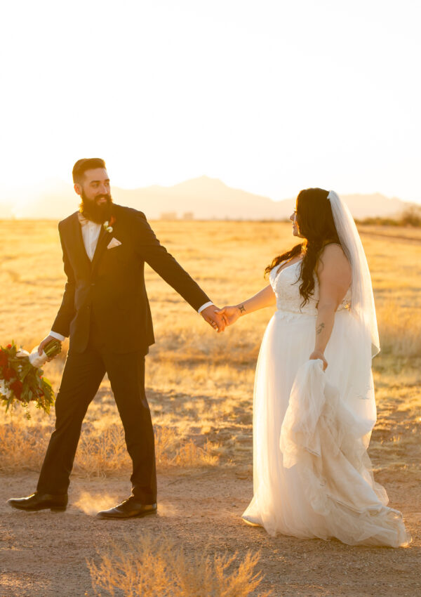 bride and groom walking outside at dusk