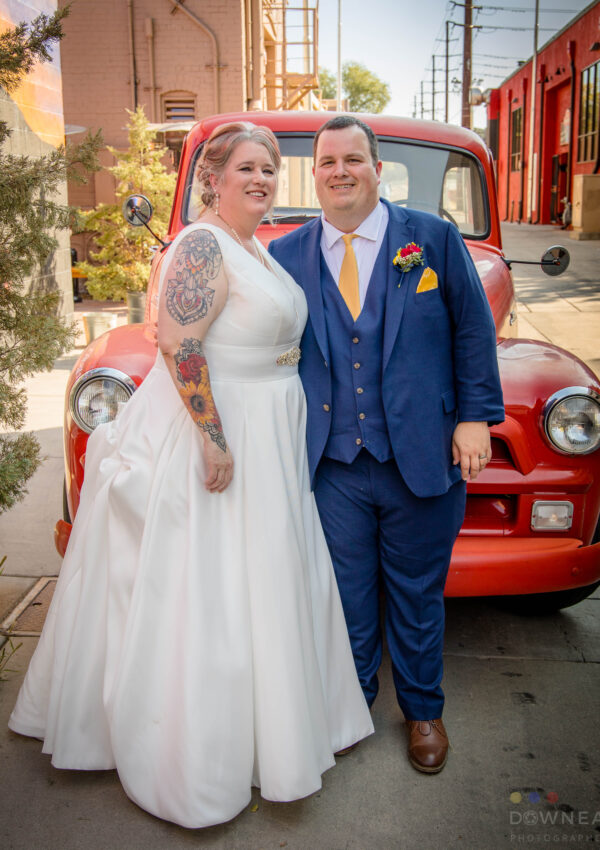 plus size bride and groom in front of classic red truck