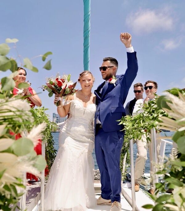 bride wearing fitted lace wedding dress on a catamaran in san diego california