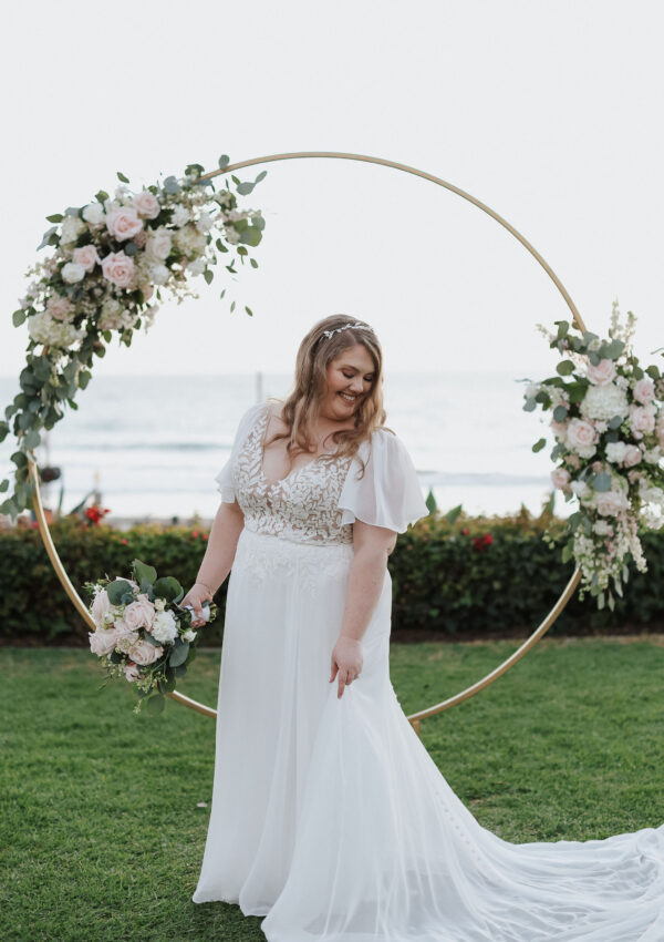 mid size bride wearing chiffon aline wedding dress with custom sleeves