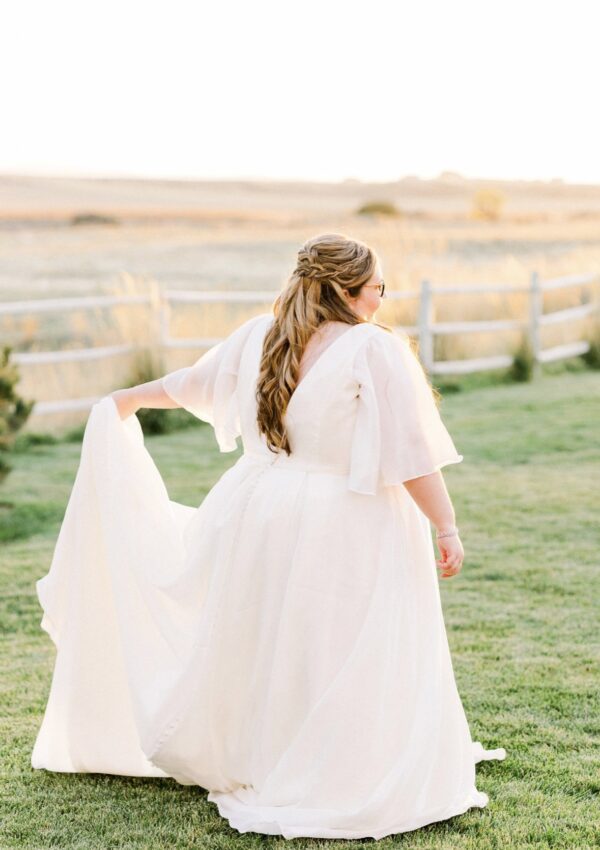 plus size organza ballgown wedding dress with sleeves chandler arizona bridal shop